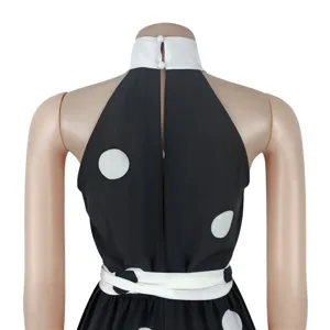 Back view of women polka dot halter sleeveless jumpsuit with pearl buttons and waist belt.
