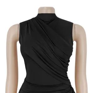 Close-up detail of the black sleeveless top featuring elegant diagonal ruching and draping.
