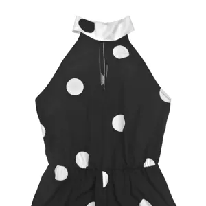 Detailed view of womens black and white polka dot halter neck sleeveless jumpsuit top section.