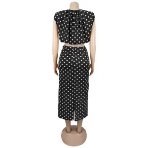 Back view detail of women's black and white polka dot sleeveless crop top and midi skirt set.