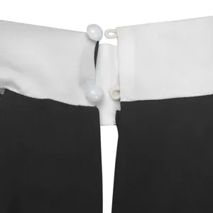 Detail view of the elegant black and white jumpsuit collar featuring secure button closure.