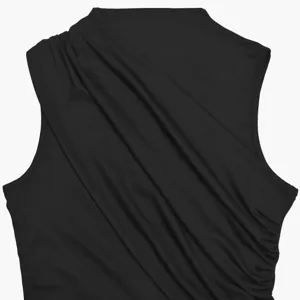 Black sleeveless asymmetric draped top, stylish ruched design for modern women detail shot.