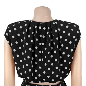 Detailed back view of a chic black sleeveless top featuring elegant white polka dots.
