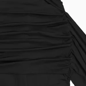 Detailed shot of black ruched fabric, showing intricate gathers and premium clothing texture.