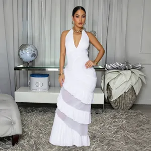 White halter neck long dress featuring tiered ruffles and elegant sheer panels for detail.