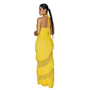 Detail view of the yellow halter backless maxi dress with stunning tiered ruffles.