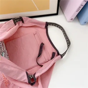 Pink casual canvas tote shoulder bag with ethnic straps and large capacity for daily commuting.