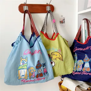 Detailed shot of casual canvas tote bags featuring cute dog embroidery and stylish lettering.