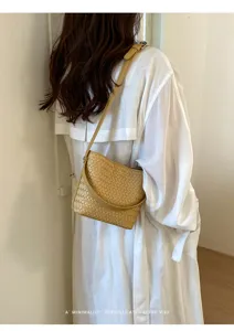 Detailed view of women woven bucket shoulder bag in stylish yellow, chic and retro design.