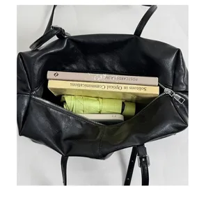 Detailed top-down view of the black boston bag interior, showcasing large capacity storage for daily essentials.