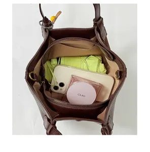 Detailed top view of dark brown leather bucket bag interior showcasing ample storage space.
