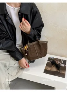 Retro brown suede handbag for women, casual commuter tote bag with cute floral charm, chic.