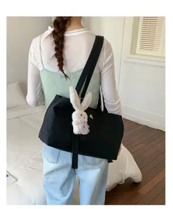 Korean style black canvas tote bag with cute plush rabbit pendant, large capacity casual shoulder bag.