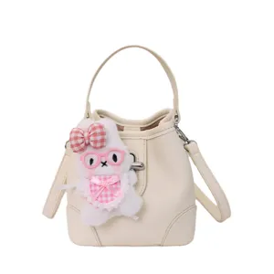 Chic lychee pattern bucket bag with cute bunny plush keychain, elegant shoulder bag for women.