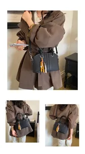 Women commuter large capacity shoulder bag stylish black tote handbag with wooden bead charm.