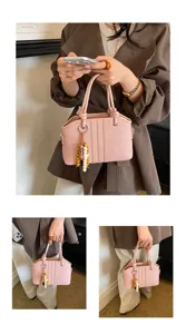Stylish pink leather handbag for women, elegant top handle tote bag with cute bead charm.