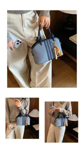 Stylish women commute handbag large capacity versatile denim crossbody bag with cute bead charm.