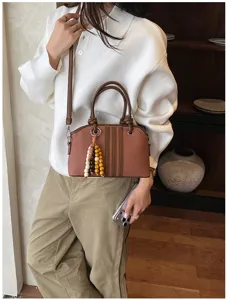 Stylish women handbag commute crossbody shoulder bag with beaded pendant and stripes.