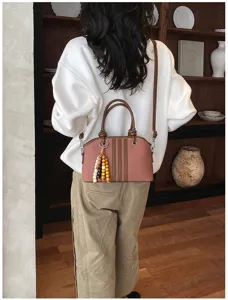 Stylish women commuter crossbody bag with chic wooden beads and elegant stripe design.