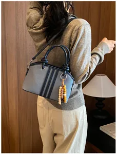 Casual canvas women shoulder bag with stylish leather trim and cute wooden beaded charm.