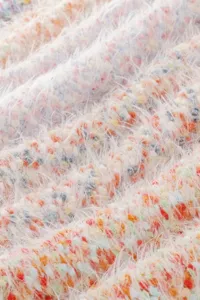 Close-up detail of ultra-soft multicolored fuzzy yarn texture, cozy knitted warm fabric.