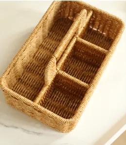 Handwoven multi-compartment wicker storage basket with handle, ideal for desktop organization.