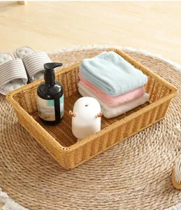 Closeup of the woven storage basket detail showing neat organization with towels and accessories.