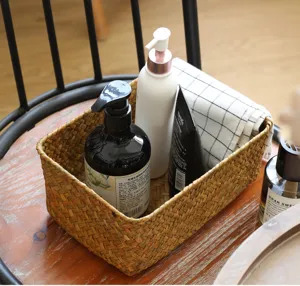 Woven storage basket for desktop sundries, straw rectangular organizer for cosmetics and home use.