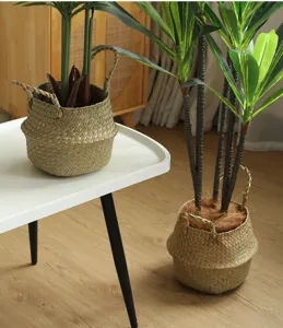 Detailed view of the natural seagrass woven storage basket and artificial potted green plant.