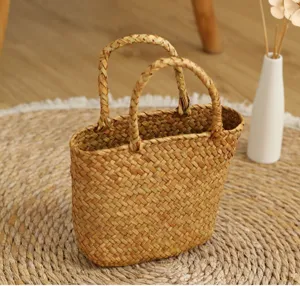 Handmade straw woven handbag detail shot, natural material, double handles, rustic style.