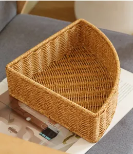 Detailed view of the triangular wicker storage basket for corner desktop organization.