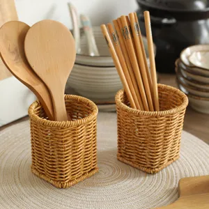 Imitation rattan woven storage basket with wooden spoons and chopsticks, desktop organizer.