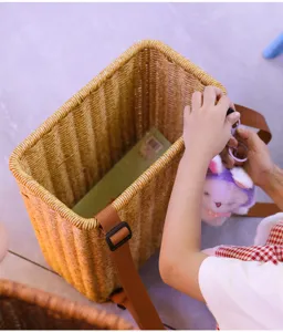 Children woven rattan backpack cute outdoor storage basket with adjustable brown shoulder straps.