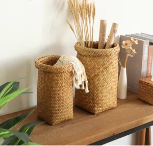 Detailed closeup shot of woven straw storage baskets with dried wheat on a wooden table.