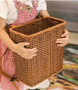 Children woven backpack detail shot, brown imitation rattan wicker storage basket for kids outdoor use.