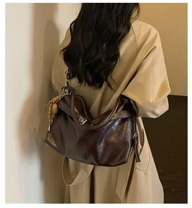 Brown oil wax leather shoulder bag for women, stylish slouchy commuter cross-body bag.