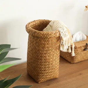 Round woven straw storage basket and planter pot cover for home organization and decor.