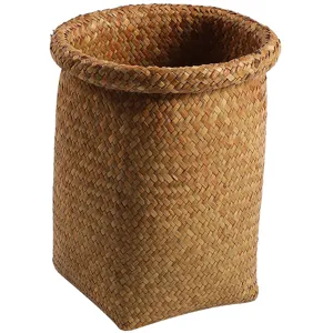 Round woven straw storage basket, natural seagrass plant pot cover and decorative waste bin.