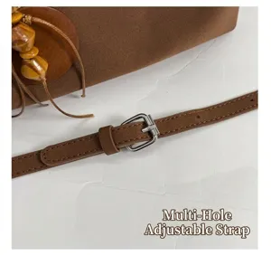Detailed close-up shot of the retro handbag adjustable strap with metal buckle and wooden beads.