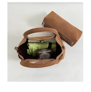 Detailed top view of the brown suede tote bag showing internal capacity and matching pouch.