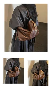 Detail view of the stylish brown waxed leather shoulder bag showing texture and strap design.