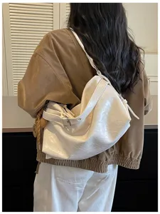 Detail shot of women's white oil-wax leather hobo shoulder bag for daily commute use.