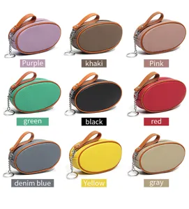 Oval leather coin purse with zipper closure, wrist strap and keychain in multiple colors.