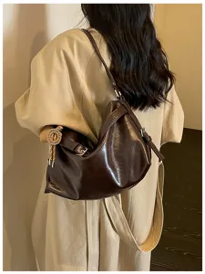 Detailed view of women's minimalist oil-wax leather shoulder bag for chic daily commuting style.