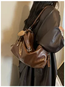 Detailed view of brown oil wax leather shoulder bag showcasing soft texture and large capacity.