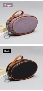Genuine leather mini coin purse detail view, oval shape with keychain and zipper closure.