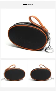 Black leather coin purse with orange trim, mini zipper pouch and keychain ring for women.