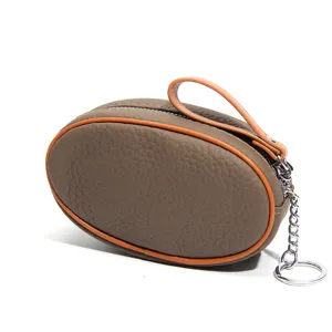 Mini genuine leather coin purse with contrast color piping, zipper closure and key ring chain.
