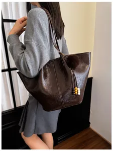 Retro oil wax leather tote bag for women, large capacity commuter shoulder bag with cute pom-pom charm.