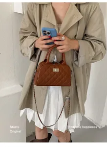 Brown quilted bowling handbag detail featuring a metallic turn-lock closure and chain strap.